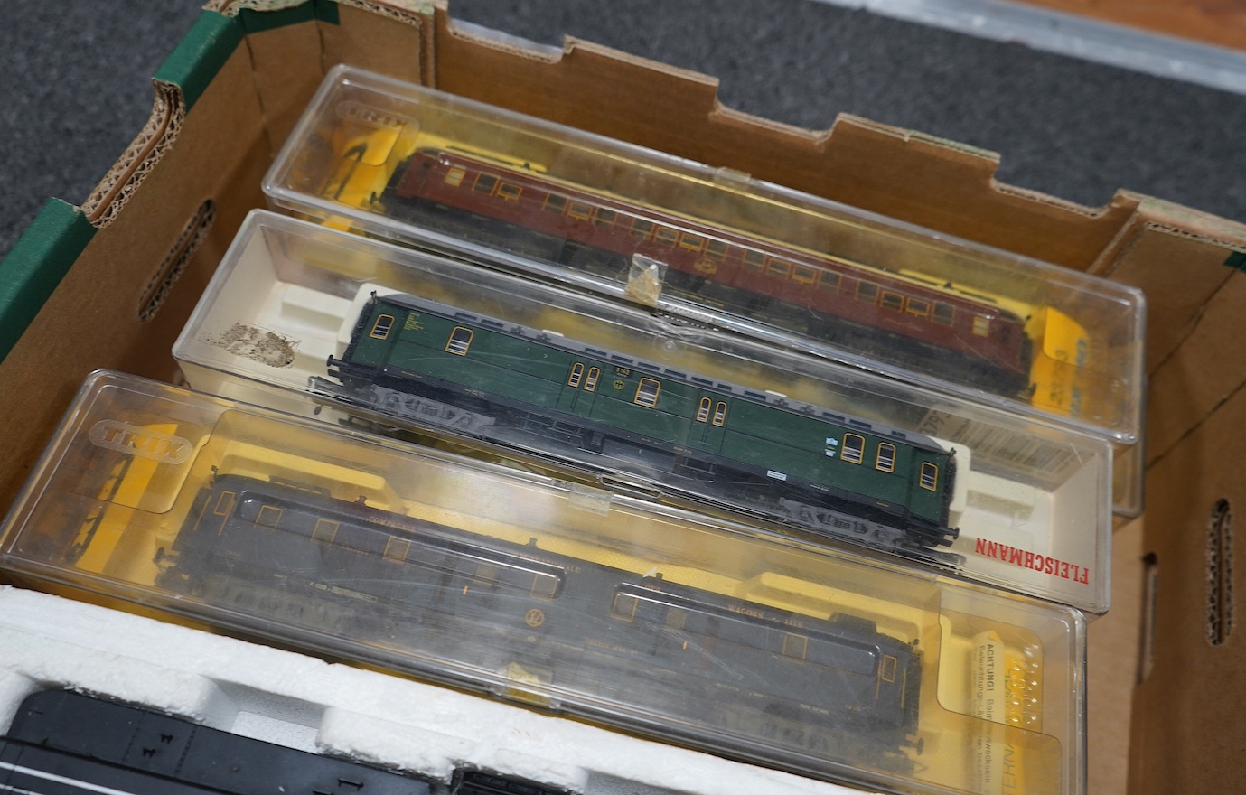 Twenty-four HO gauge model railway by Lima, Trix, Fleischmann, etc. including a German DB 4-6-2 tender locomotive, 10 001, fourteen Continental outline bogie coaches, 4-wheel coaches, and freight wagons. Condition - fair